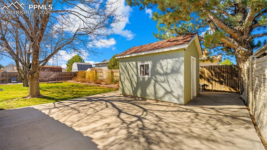 Image 30 of 44: View of shed with a fenced backyard