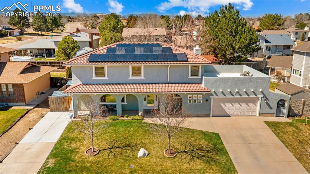 Image 32 of 44: View of front of house with solar panels, a residential view, a gate, and c