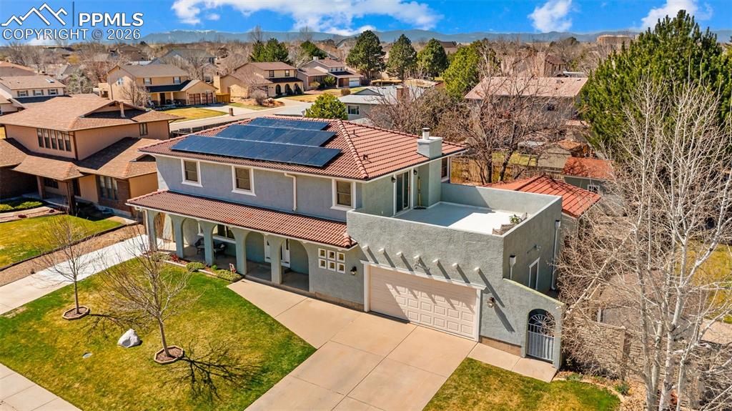 Image 34 of 44: Aerial perspective of suburban area featuring a mountain backdrop