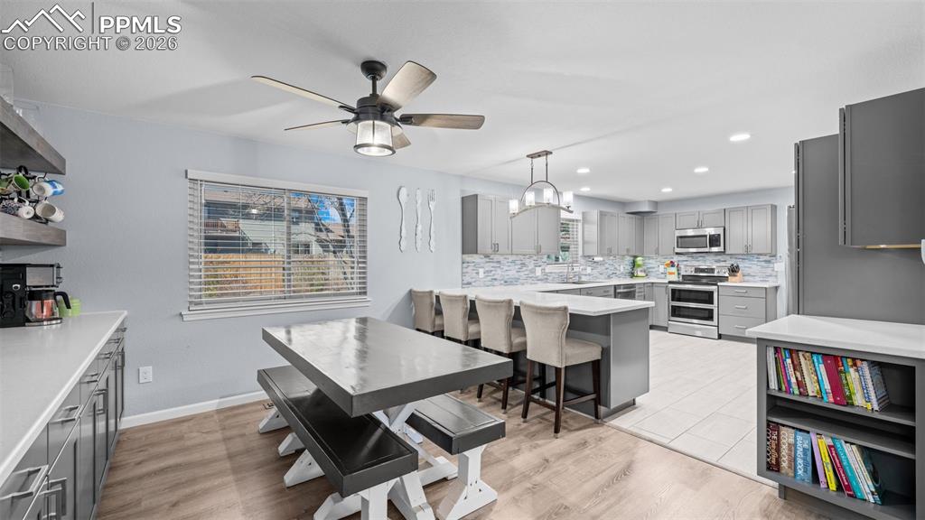 Image 4 of 44: Dining space with hanging lights, light wood finished floors, healthy amoun