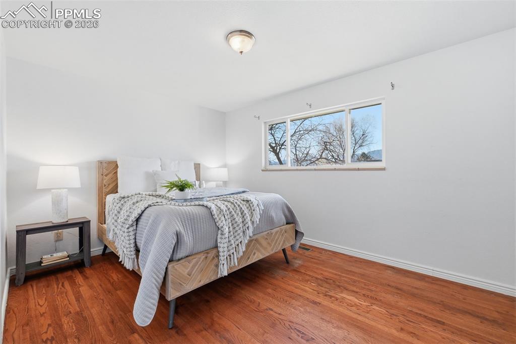 Image 16 of 32: Spacious Bedroom with real wood floors