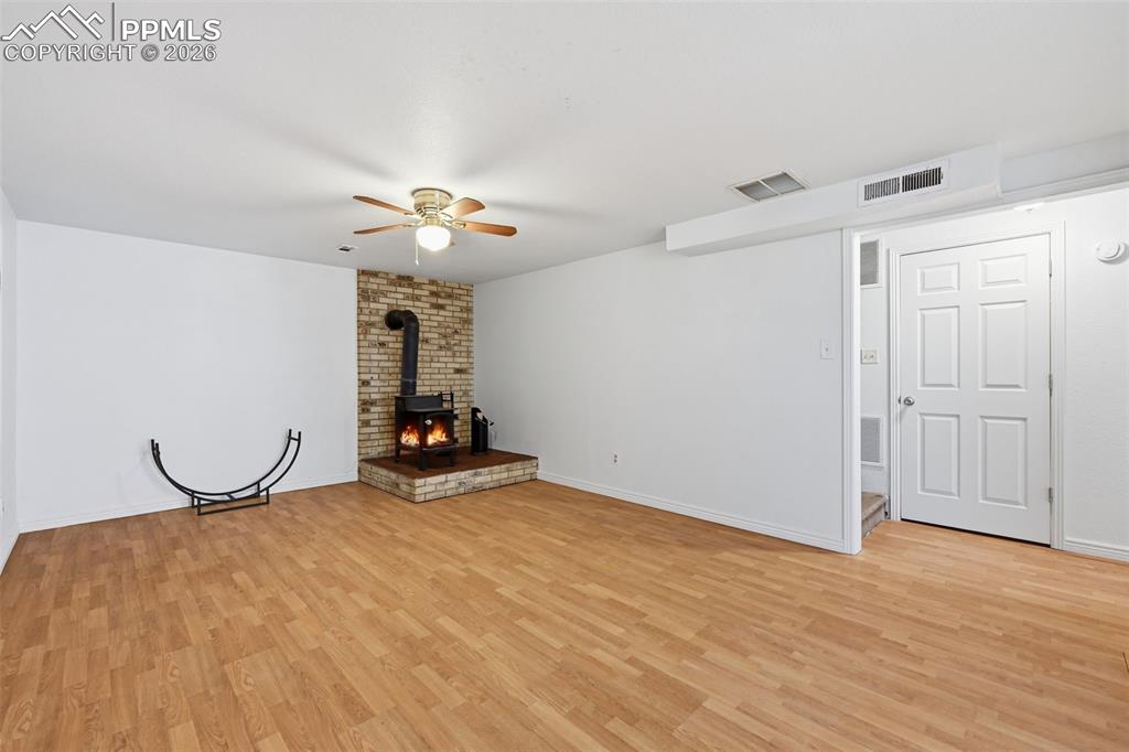 Image 19 of 32: With wood burning stove and plank flooring