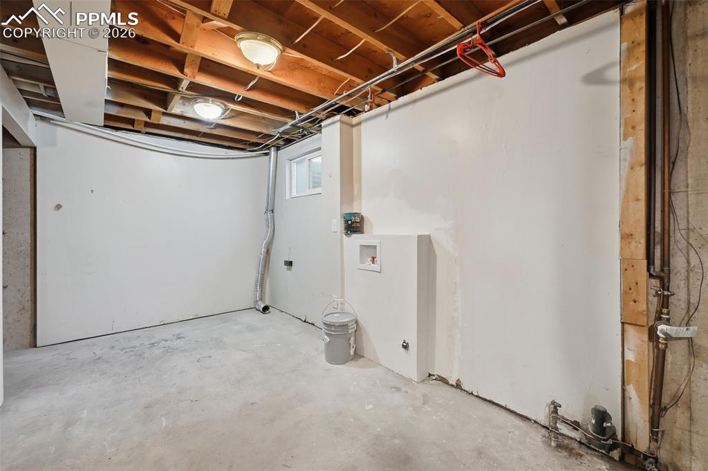 Image 26 of 32: Unfinished storage/laundry space