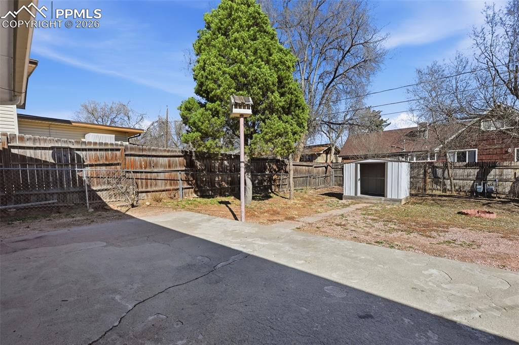 Image 29 of 32: Concrete back patio off of kitchen