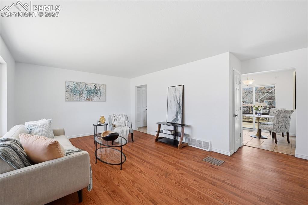 Image 5 of 32: Large family room with real wood floors