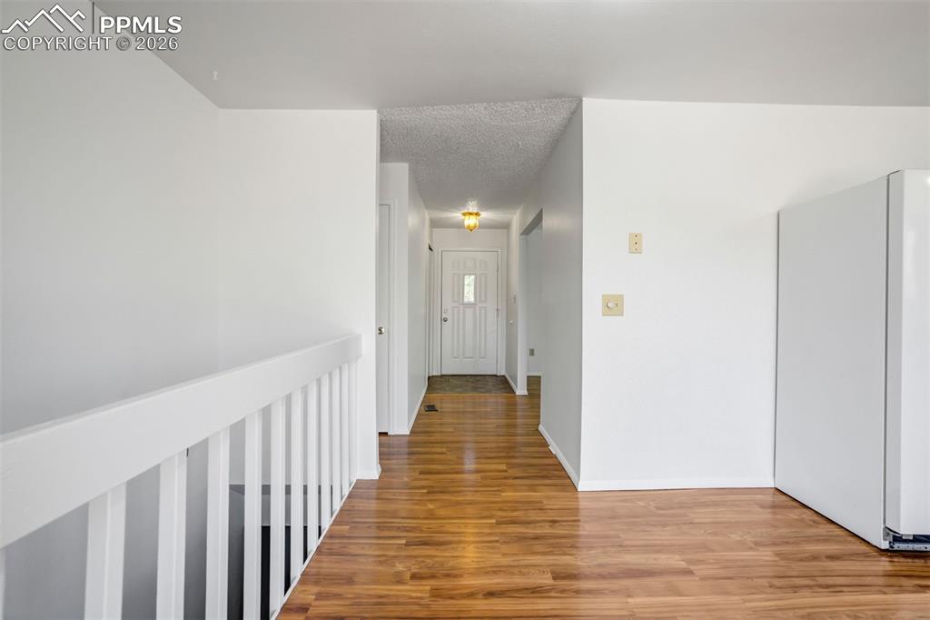 Image 17 of 50: The property features hardwood flooring and bright white walls