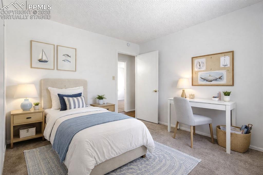 Image 30 of 50: Virtually Staged - This inviting room features neutral carpeting, a light-c