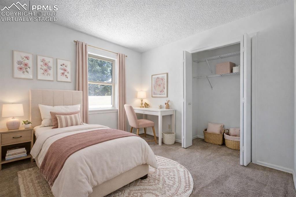 Image 32 of 50: Virtually Staged - This bedroom features carpeted flooring, a window with c