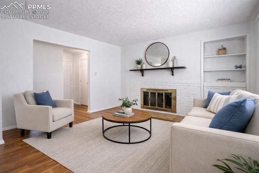 Image 5 of 50: Virtually Staged - This inviting living area features hardwood floors and a