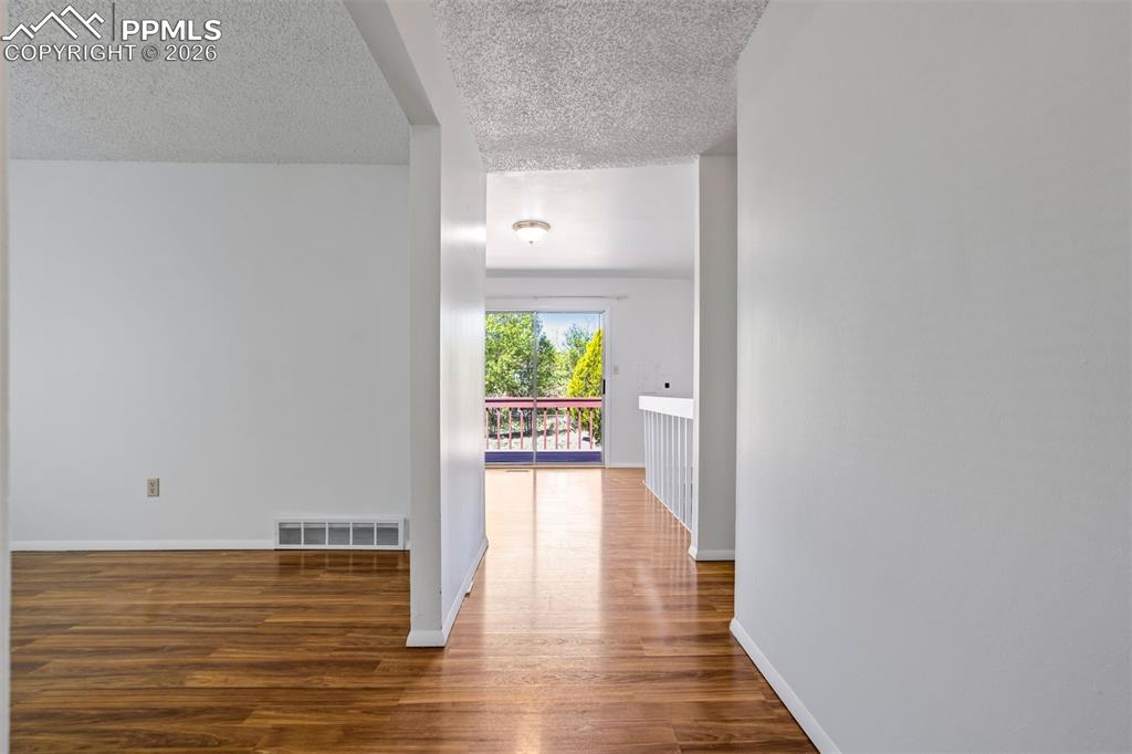 Image 9 of 50: The interior features hardwood flooring and white walls, creating a bright 