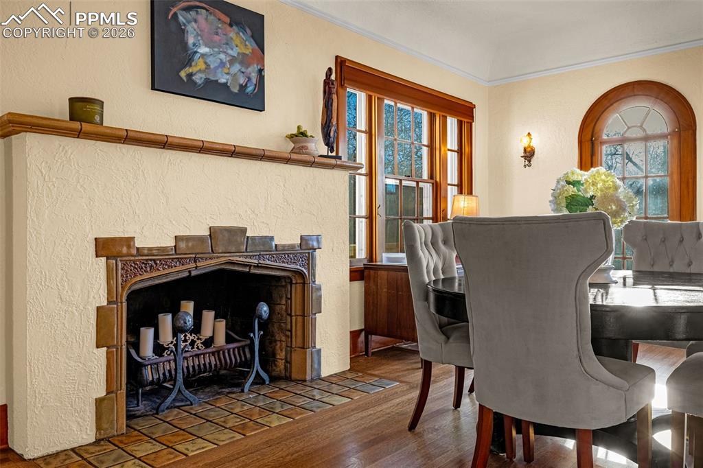 Image 23 of 50: Formal Dining Room with wood burning fireplace and original tile
