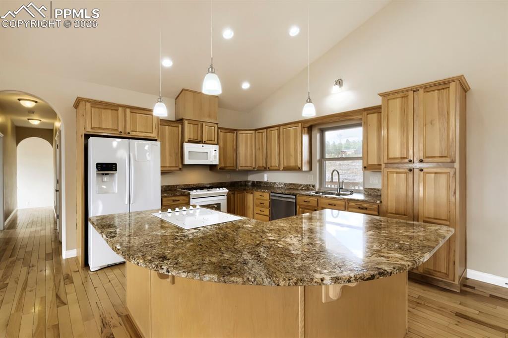 Image 13 of 48: The kitchen features two stove tops with one being gas and the other electr