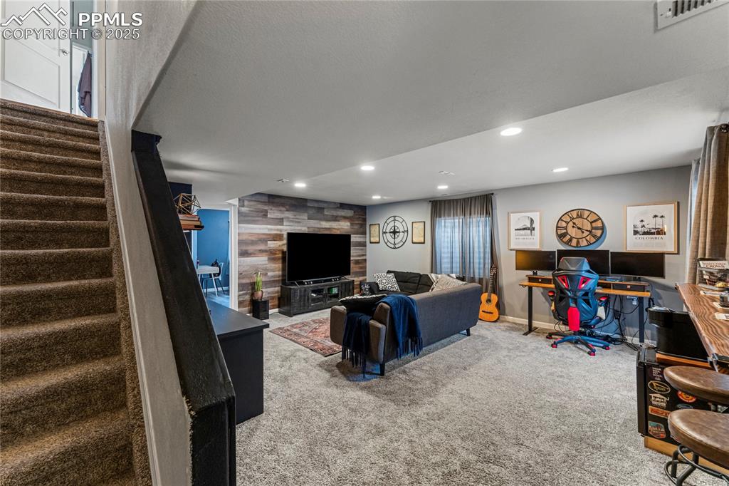 Image 28 of 43: Living area with visible vents, recessed lighting, stairway, and carpet flo