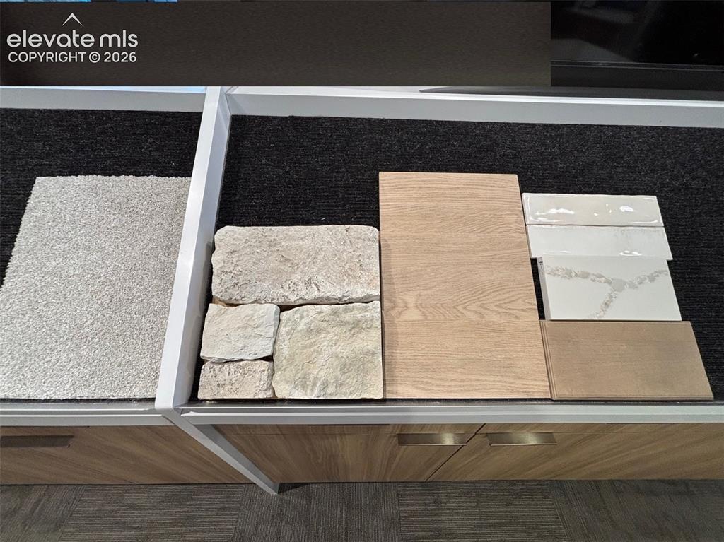 Image 25 of 38: Carpet, Fireplace Stone, and Kitchen Finishes