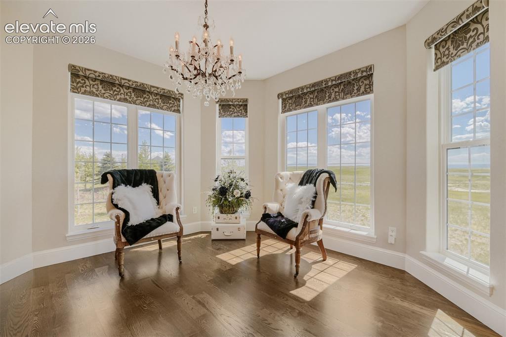 Image 24 of 50: sitting area surrounding by huge windows and custom coverings