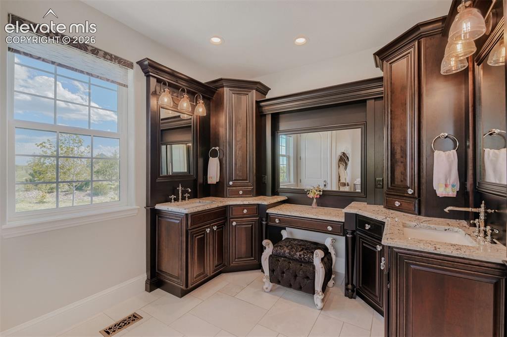 Image 25 of 50: Beautiful, custom cabinetry, make up seating