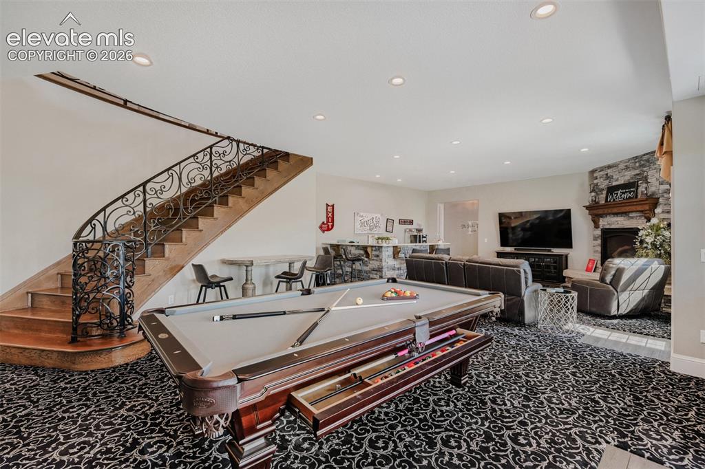 Image 32 of 50: Lower level ELEGANCE. Check out the staircase