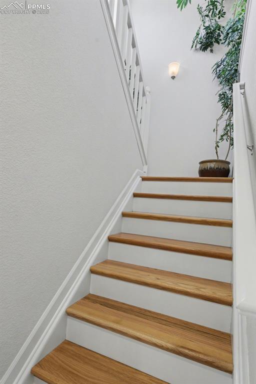 Image 11 of 38: Hardwood stairs and hardwood flooring in the loft