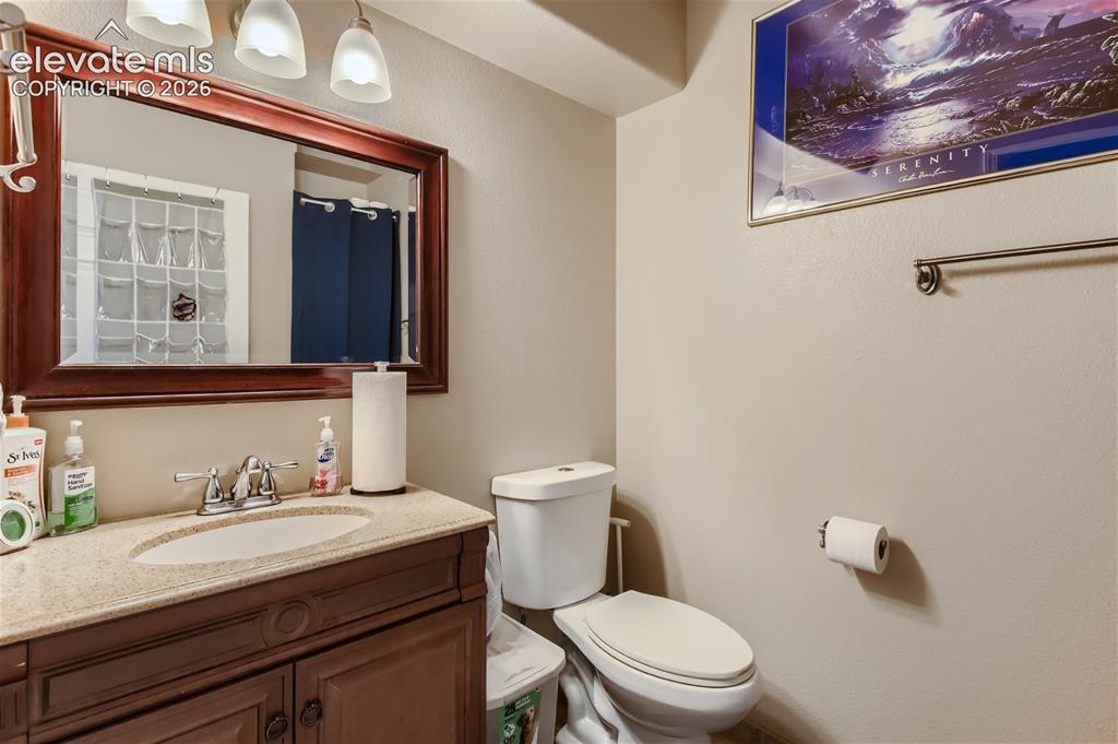 Image 17 of 49: Vanity with a polished chrome faucet and an oval undermount sink, complemen