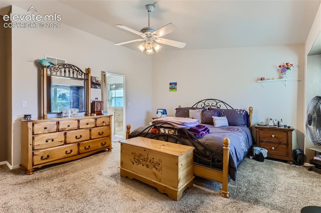 Image 19 of 49: Recessed ceiling with ceiling fan, wall-to-wall carpeting, and an adjacent 