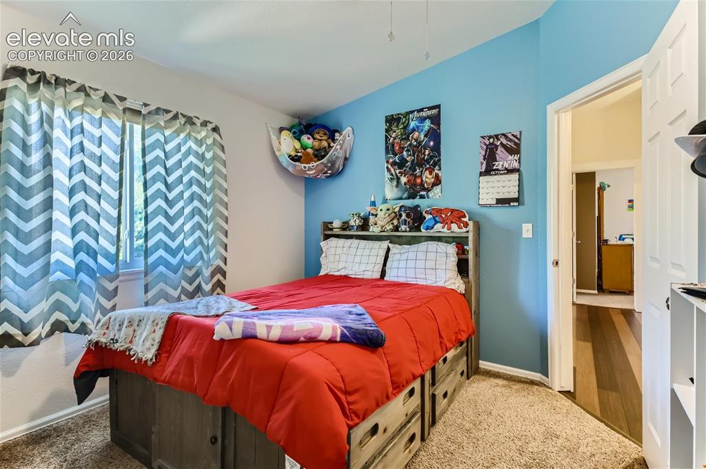 Image 25 of 49: Carpeted flooring, window with natural light, two-tone wall paint, built-in