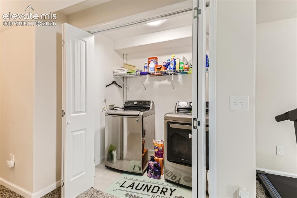 Image 33 of 49: Dedicated laundry area featuring a washer and dryer