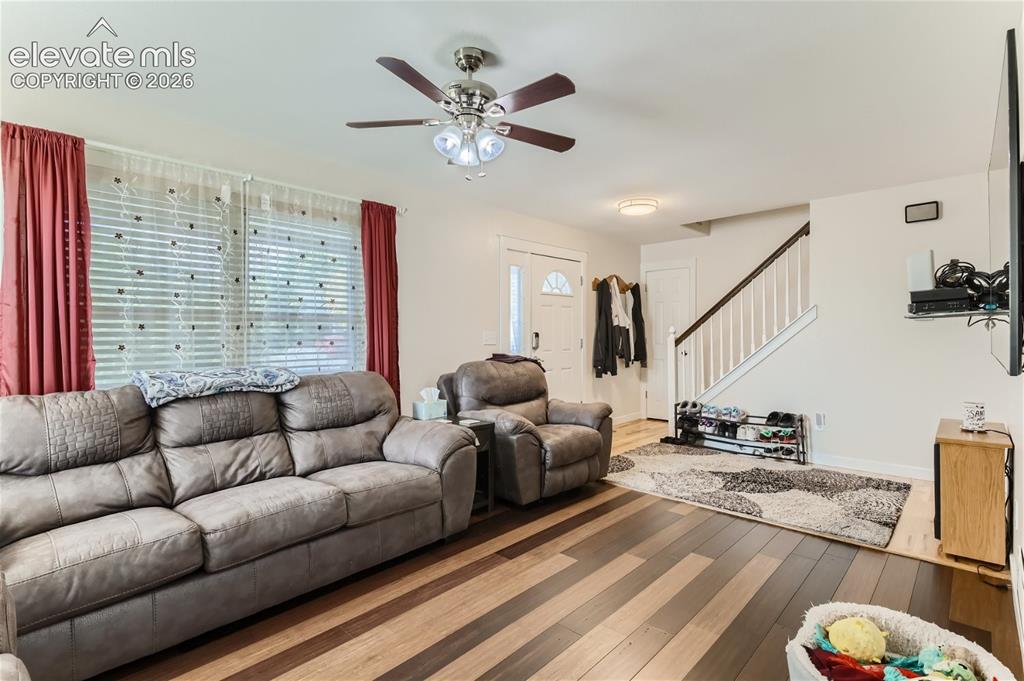 Image 6 of 49: Wood-finish flooring, staircase with white risers and dark wood handrail, c