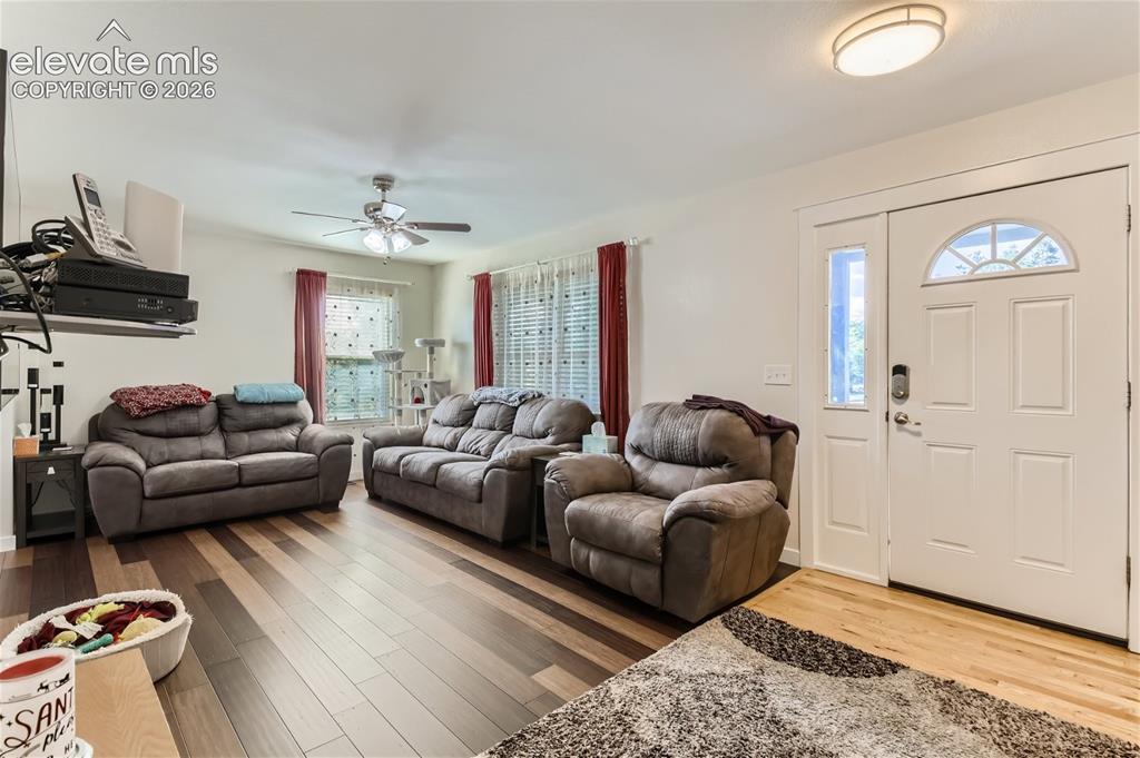 Image 7 of 49: Wood-finish flooring throughout, ceiling fan with integrated lighting, and 