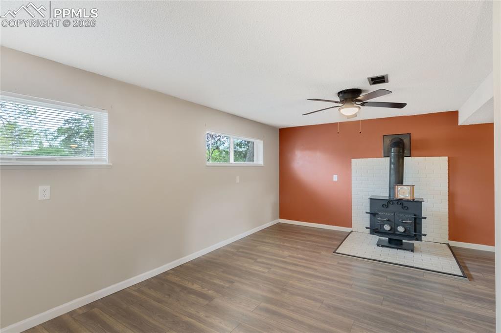 Image 19 of 31: Lower level with woodburning stove, laundry, full bath and separate entranc