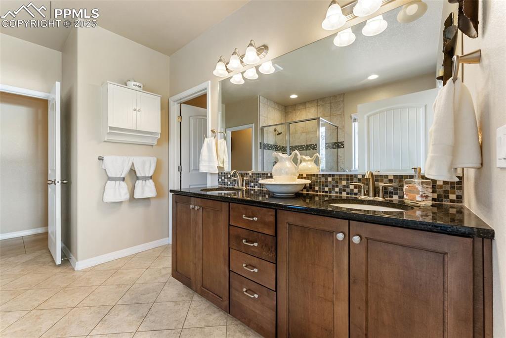 Image 21 of 50: Full bath with walk-in shower, bathtub, double vanity, private water closet