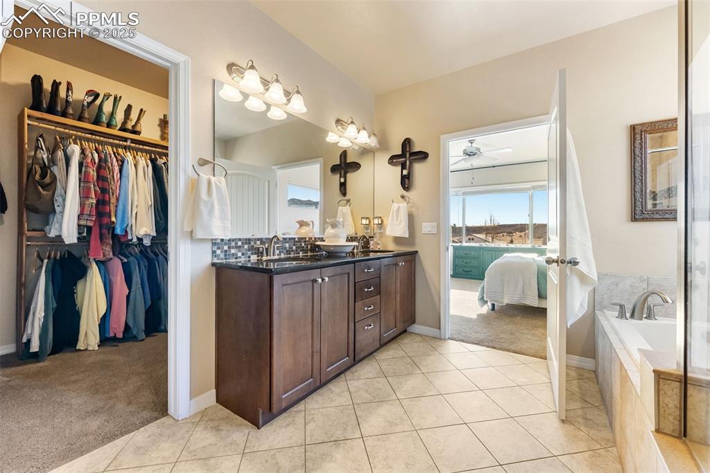 Image 22 of 50: Full bath with walk-in shower, bathtub, double vanity, private water closet