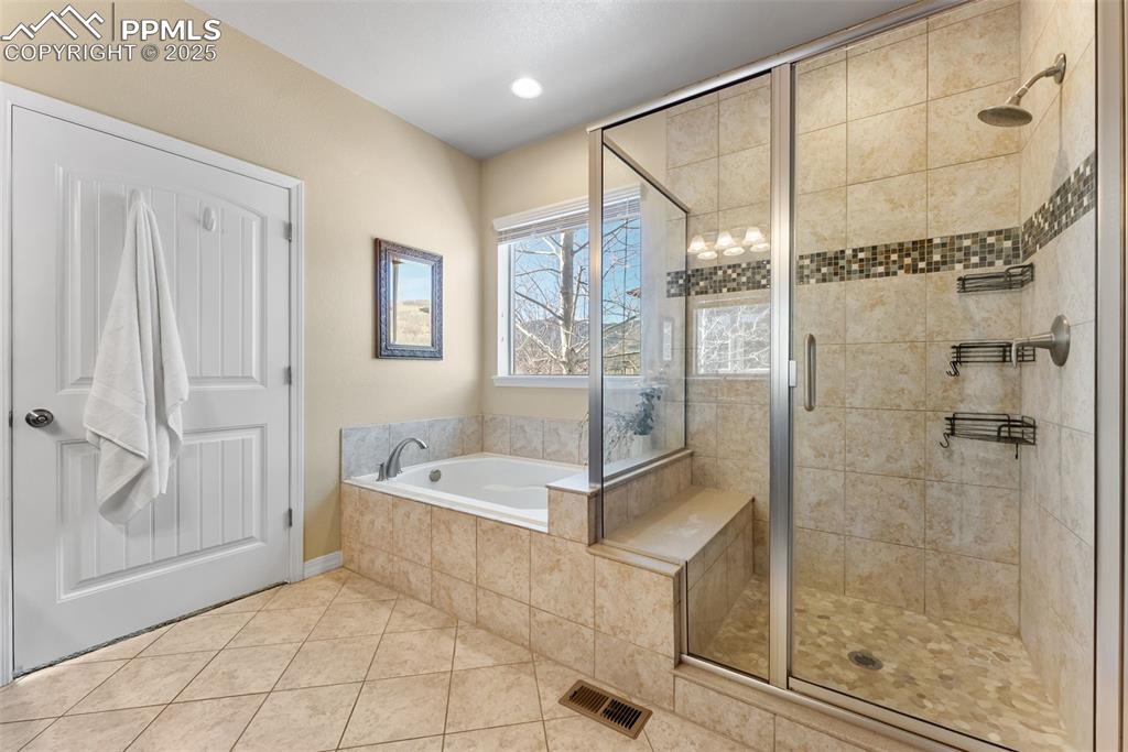 Image 23 of 50: Full bath with walk-in shower, bathtub, double vanity, private water closet