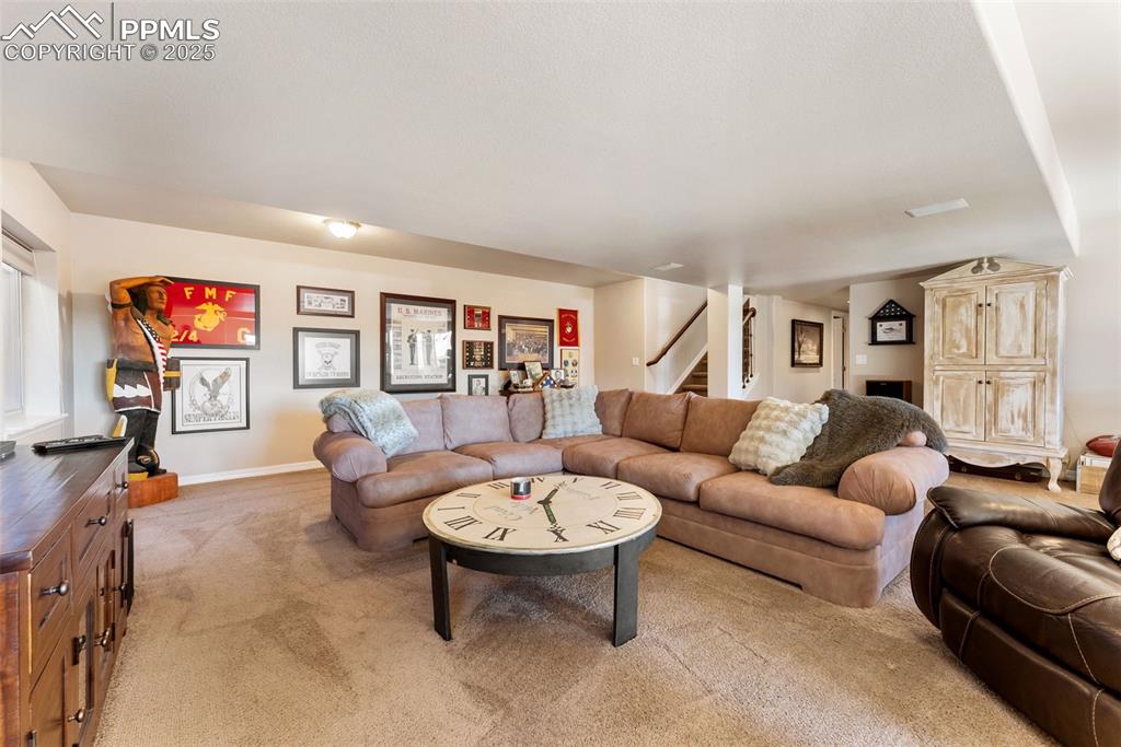 Image 29 of 50: Family room with walkout to covered patio with hot tub