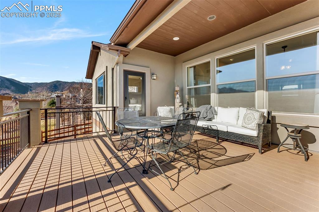 Image 37 of 50: Composite deck featuring a mountain and lake view outdoor dining space