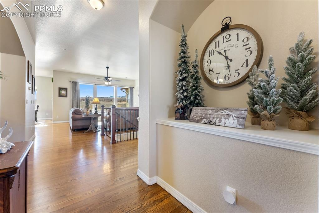 Image 4 of 50: Warm hardwood flooring in entryway and through main level