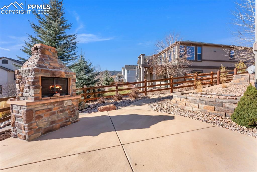 Image 40 of 50: View of patio with a mountain view and custom wood burning fireplace