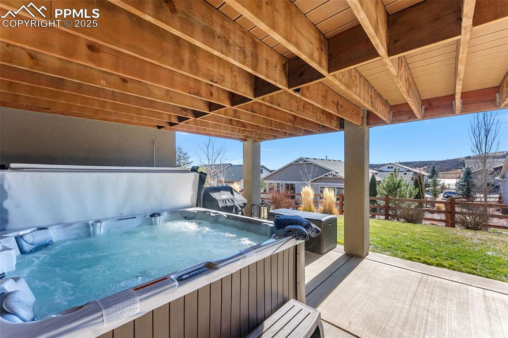 Image 42 of 50: View of covered patio / terrace featuring grilling area, a residential view