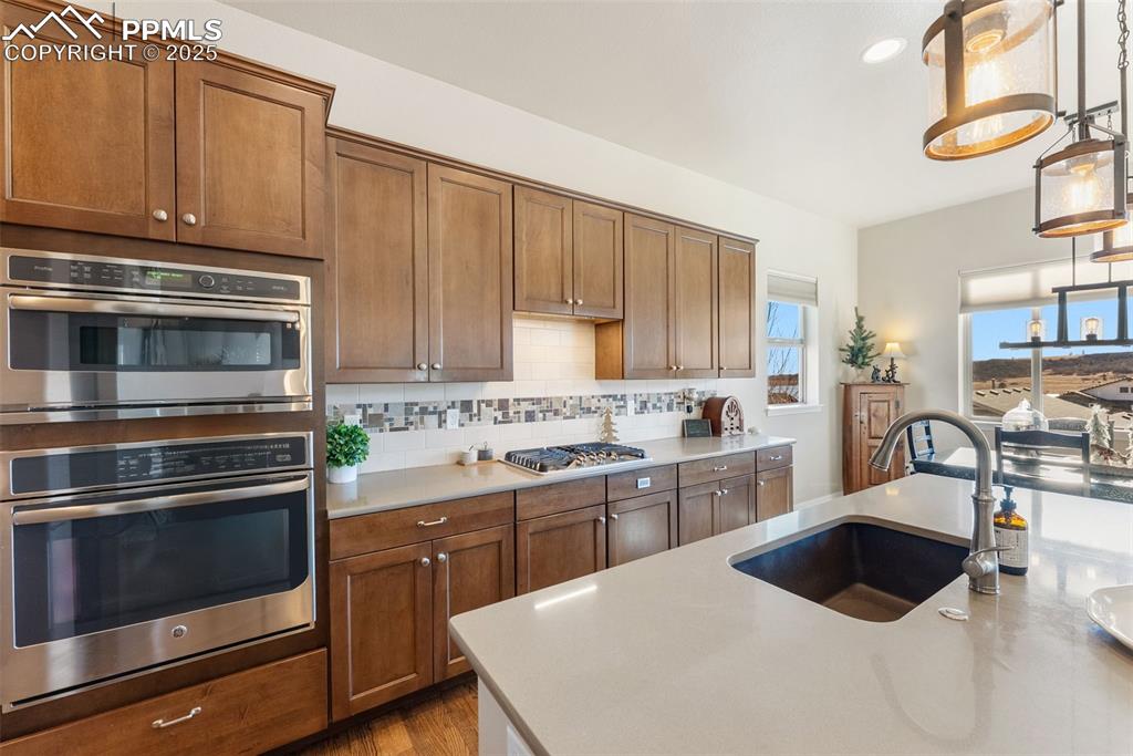 Image 5 of 50: Kitchen featuring soft close cabinets, pantry, stainless steel appliances,
