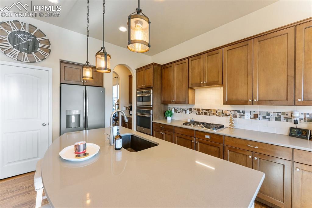Image 9 of 50: Kitchen with appliances with gas cooktop, tasteful backsplash, soft close c