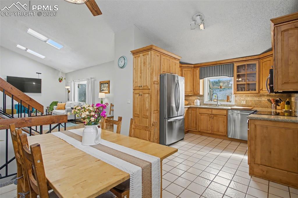 Image 11 of 42: Kitchen with tile floors and stainless steel appliances
