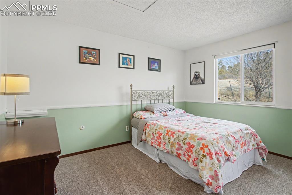 Image 24 of 42: Upper level bedroom with ample natural light