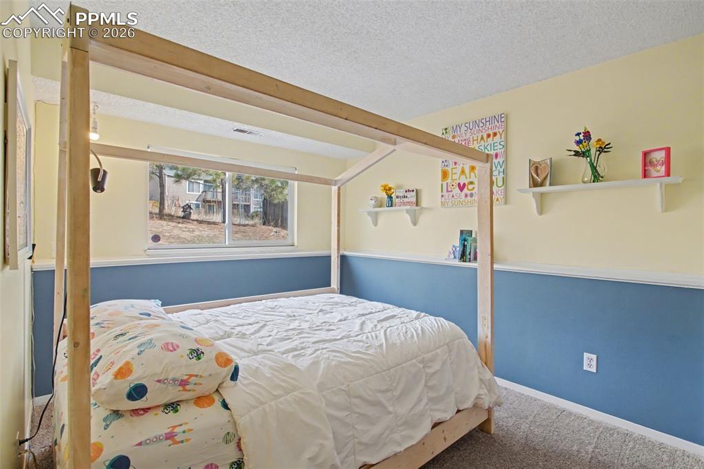 Image 26 of 42: Lower level light and bright bedroom