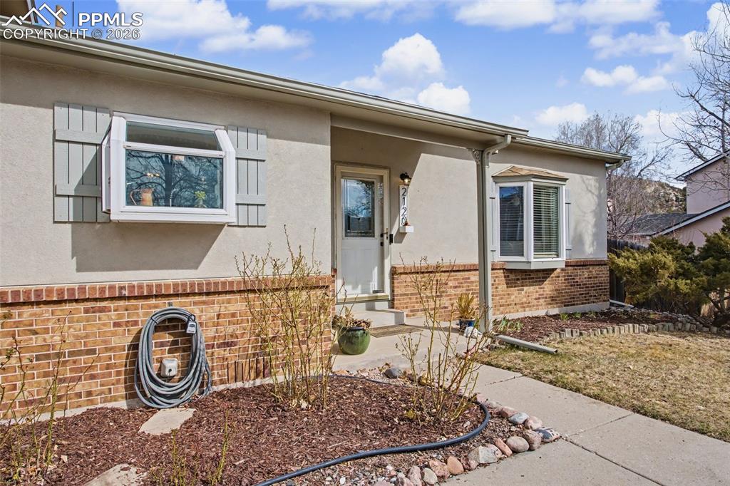 Image 4 of 42: Front with garden and bay windows