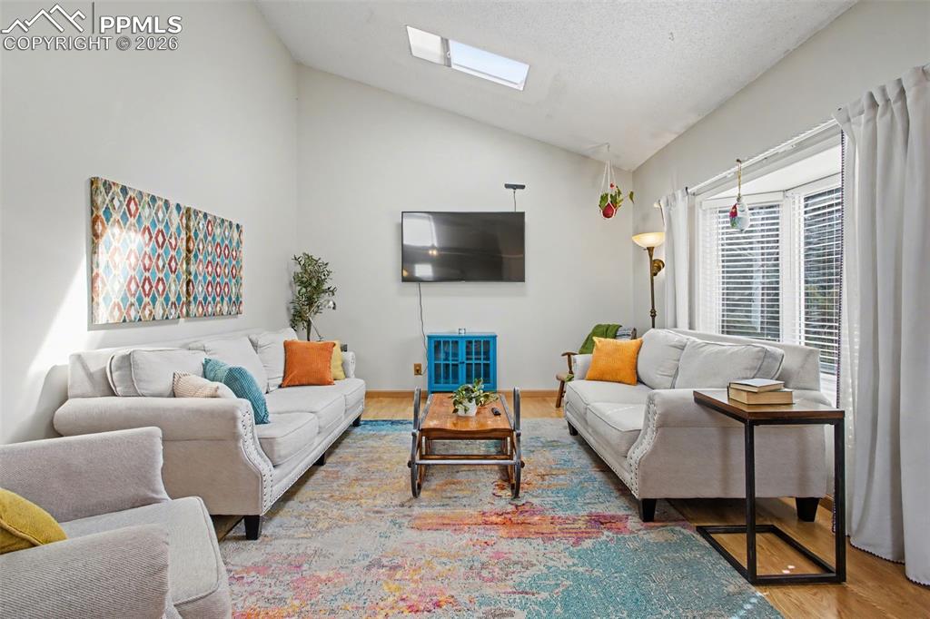 Image 7 of 42: Light & bright living room with ample natural light from bay window