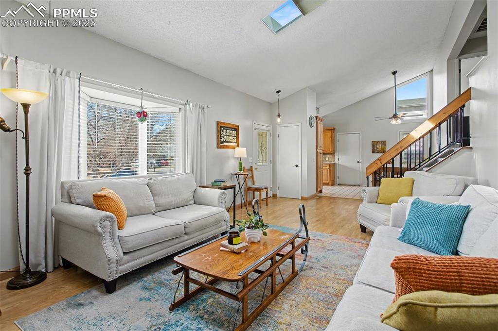 Image 8 of 42: Living room with view towards kitchen and dining area