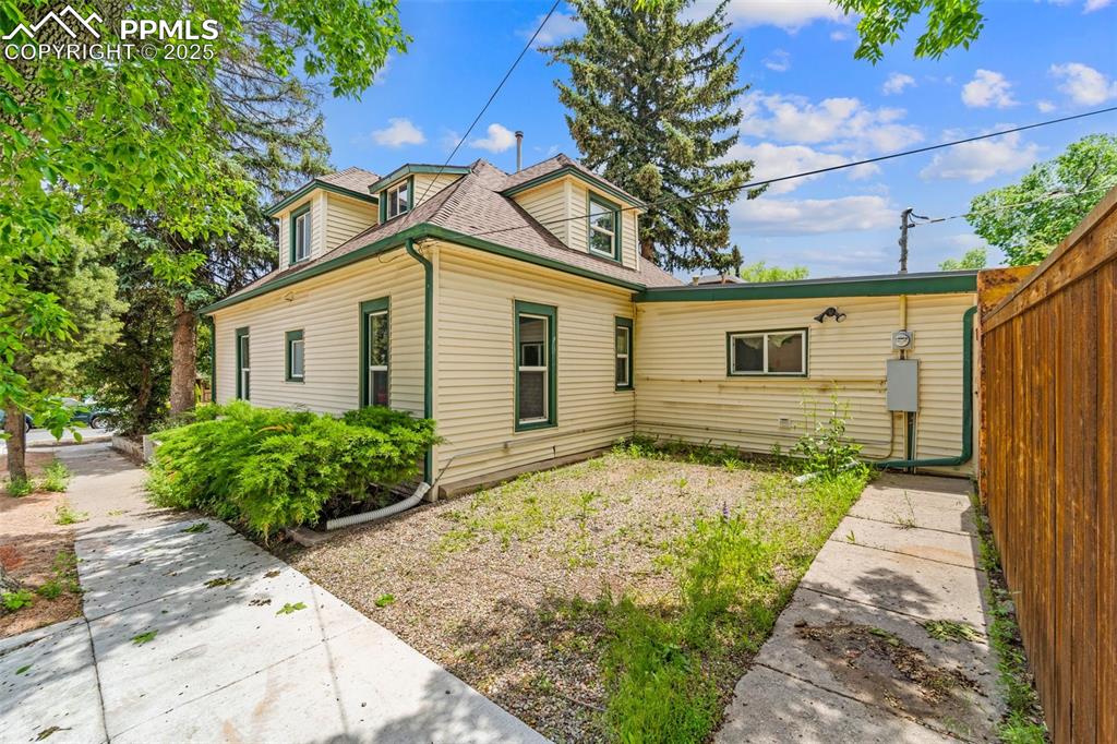 Image 15 of 48: Side view of the home with charming architectural details.