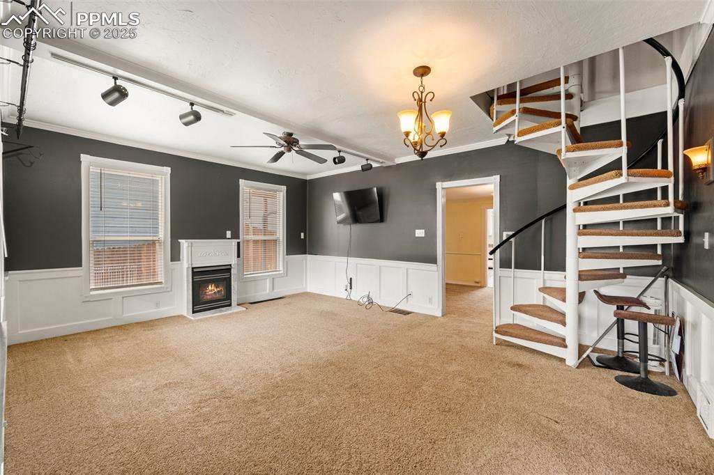 Image 20 of 48: Spacious living room with bright windows and neutral tones.