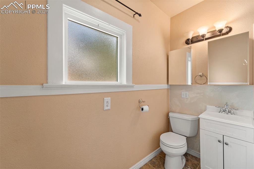 Image 23 of 48: Full bathroom with updated fixtures and natural light.