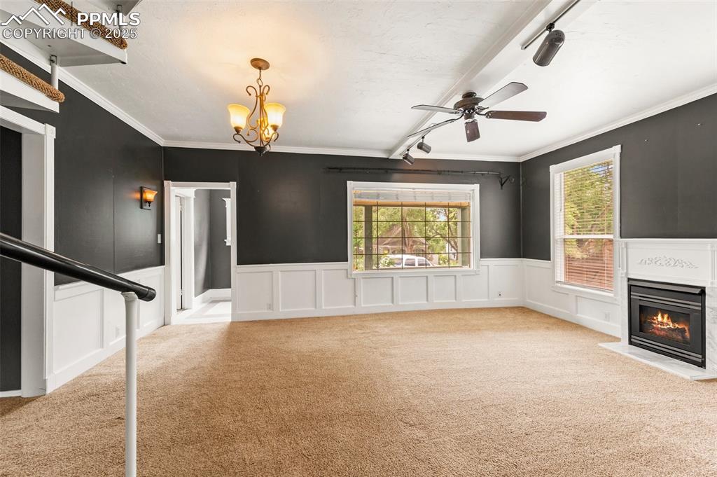Image 24 of 48: Large living room with elegant light fixture and backyard views.