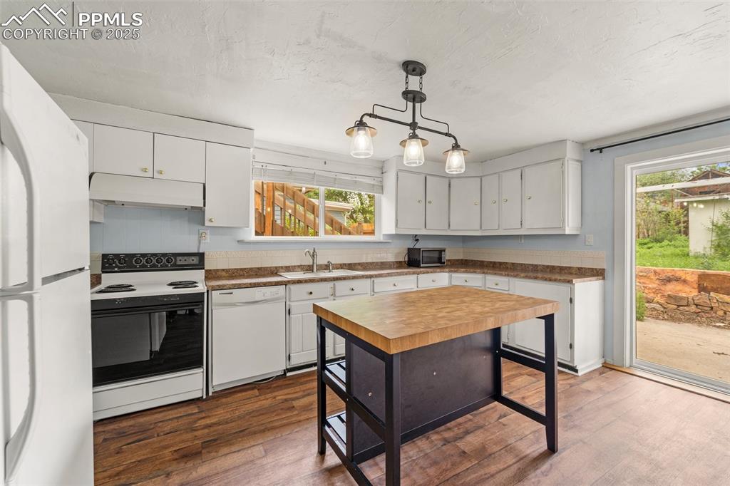Image 27 of 48: Modern kitchen with stainless steel appliances and open layout.